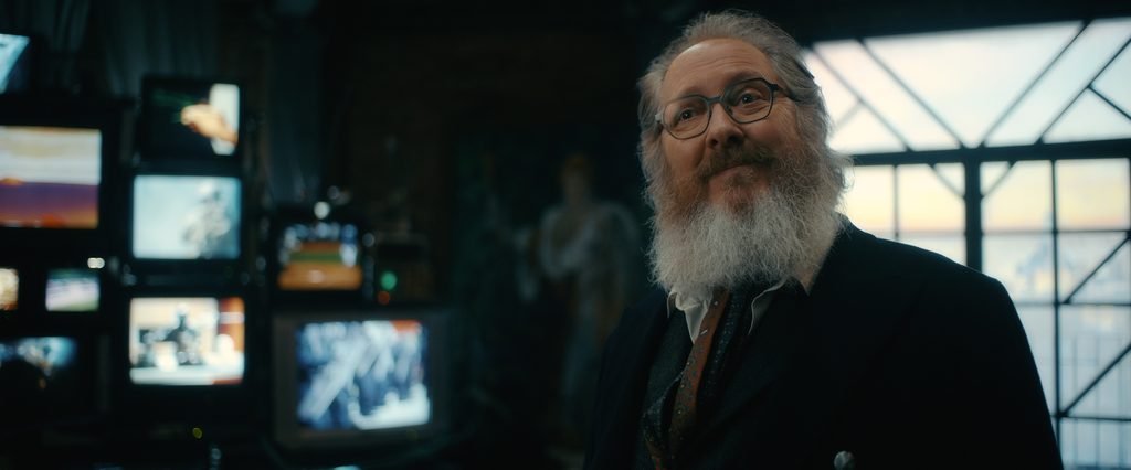 James Spader as Ultron in human form, standing in front of television screens in VisionQuest